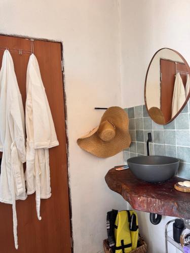 a bathroom with a wooden door and a mirror at Chalé Mansões do Rio in Casa Nova