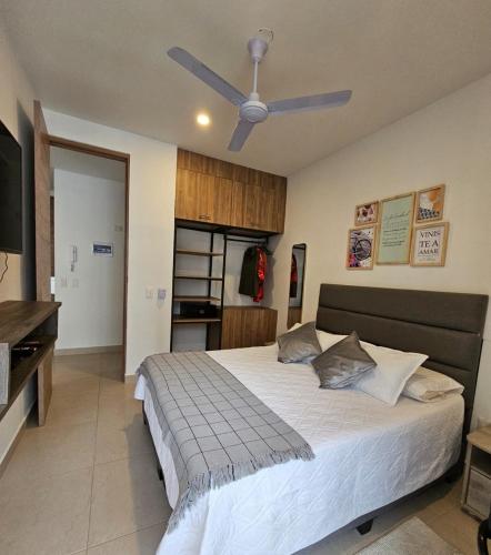 a bedroom with a bed with a ceiling fan at GabyMar salinas del mar Santamarta in Santa Marta