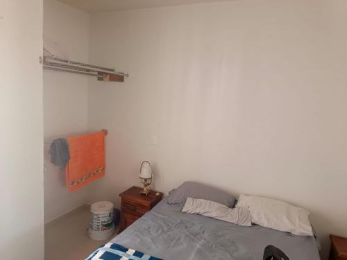 a bedroom with a bed and a lamp on a night stand at Casa Roque in El Balcón