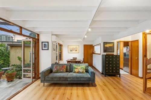 a living room with a couch and a table at Napier St in Auckland