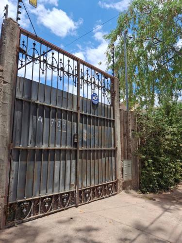a wooden gate with an iron fence at Casa con Piscina -El nogal in Las Heras