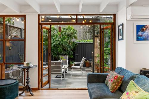 a living room with a couch and a patio at Napier St in Auckland