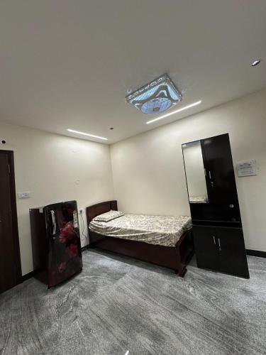 a room with a bed and a mirror in it at Diamond Ridge Living 1RK G-02 in Haidar Sāhibgūda