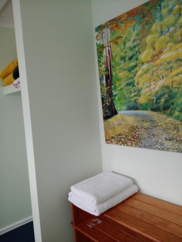 a painting hanging on a wall next to a table with a towel at Lakeside view in Cuthbert
