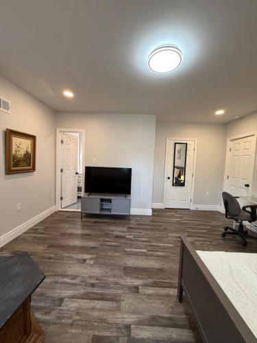a large living room with a flat screen tv at Spacious private room in a new house with private bathroom close to center city in Philadelphia