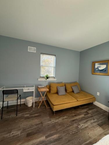 a living room with a couch and a table at Spacious private room in a new house with private bathroom close to center city in Philadelphia