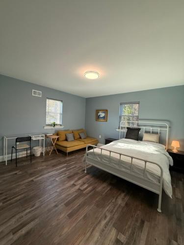 a bedroom with a bed and a couch at Spacious private room in a new house with private bathroom close to center city in Philadelphia