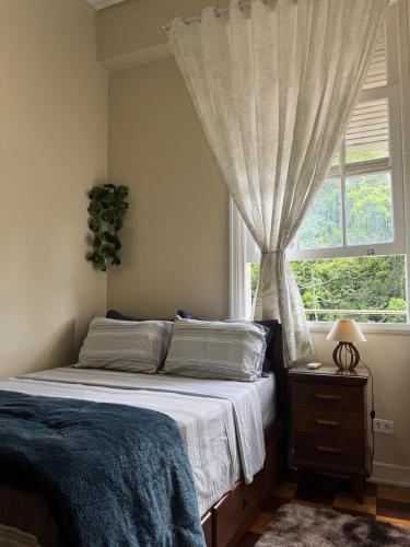 a bedroom with a bed and a window at Palácio Quitandinha in Petrópolis