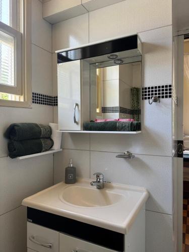 a bathroom with a sink and a mirror at Palácio Quitandinha in Petrópolis
