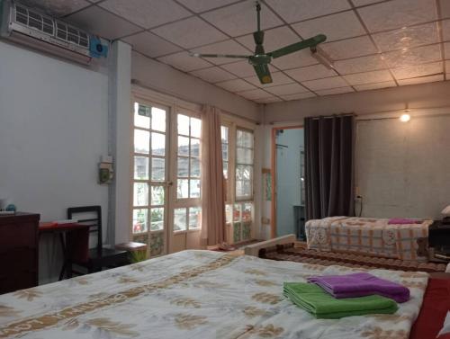 a bedroom with a large bed and a ceiling fan at Social Style Culture in Bangkok
