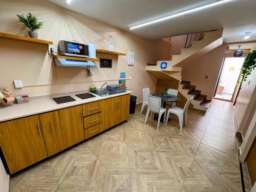 a kitchen with a counter and a table in a room at Estancia Punto Coliving Estadio in Morelia