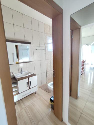 a bathroom with a sink and a toilet at Beach house - Praia Recreio Torres in Torres