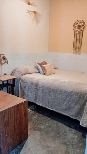 a bedroom with two beds in a room with a table at Apart Tunuyan B&B in Tunuyán
