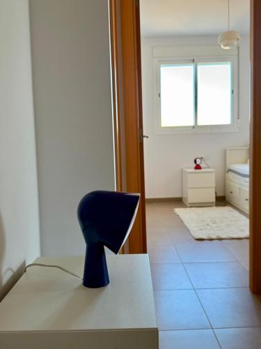 a blue chair sitting on a table in a room at PRECIOSO APARTAMENTO PLAYA DE PILES in Piles