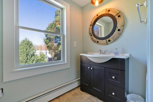 a bathroom with a sink and a window at Tidepools Retreat Poolside Family Fun in York