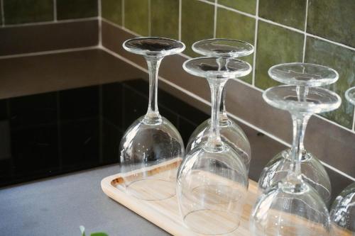 three wine glasses sitting on top of a cutting board at Marchena de los Olivos in Peñolite