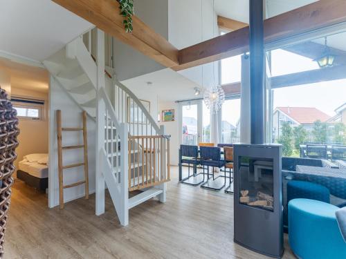 a living room with a staircase and a fireplace at Coastal Family Escape with Enclosed Garden in Renesse