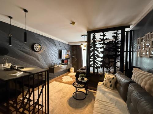 a living room with a couch and a table at Black Elegant & Spa Kop in Kopaonik