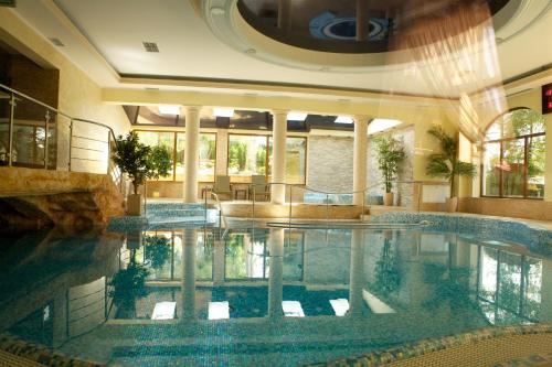 a large swimming pool in a building with a pool at Hotel Antoni in Tomaszów Lubelski