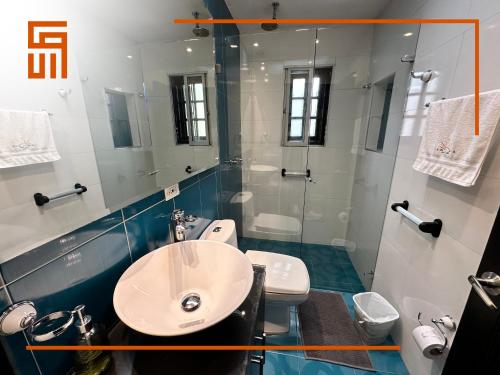 a bathroom with a sink and a toilet and a mirror at Hotel Santa Ana Luxury Rentals - 111 in Bogotá