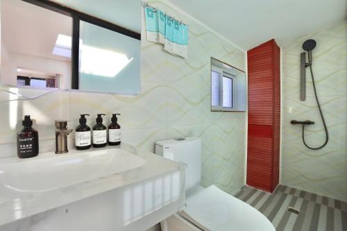 a bathroom with a white sink and a shower at 大理六悦客栈Dali Liuyue Inn in Dali