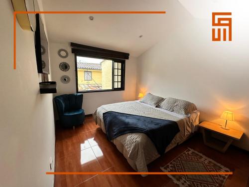 a small bedroom with a bed and a window at Hotel Santa Ana Luxury Rentals - 111 in Bogotá
