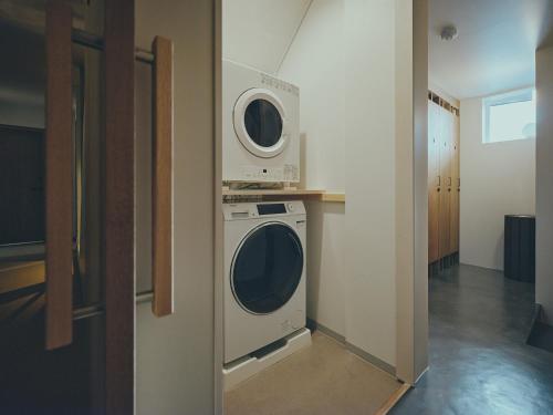 a room with a washing machine and a washer at mont - Nozawa Onsen Ski Resort in Nozawa Onsen