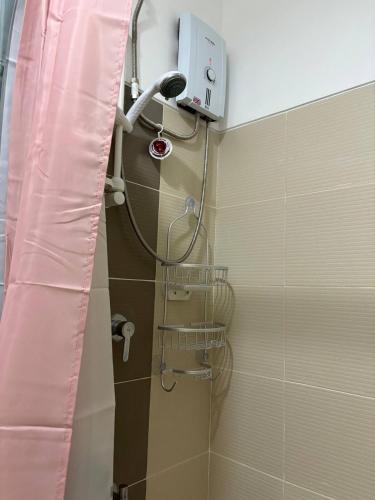 a shower in a bathroom with a pink shower curtain at RD Bliss Staycation - SMDC Condo Tower B in Kaybagal
