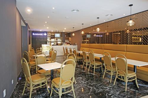 a row of tables and chairs in a restaurant at Hotel Malaysia in George Town
