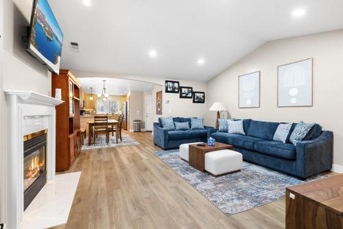 a living room with two blue couches and a fireplace at unforgettable stay at Edgewater Drive in Medford