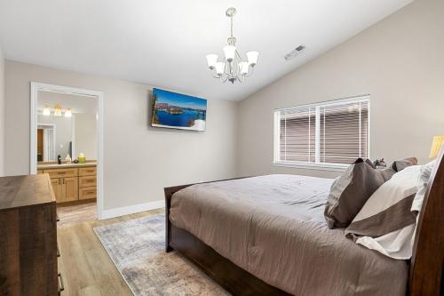 a bedroom with a large bed and a bathroom at unforgettable stay at Edgewater Drive in Medford