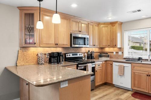 a kitchen with wooden cabinets and a granite counter top at unforgettable stay at Edgewater Drive in Medford