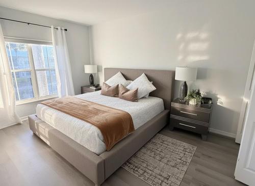 a bedroom with a large bed and a window at Spacious 2BR Lely Resort Condo with Lake View steps to Pool Hot Tub Gym in Naples