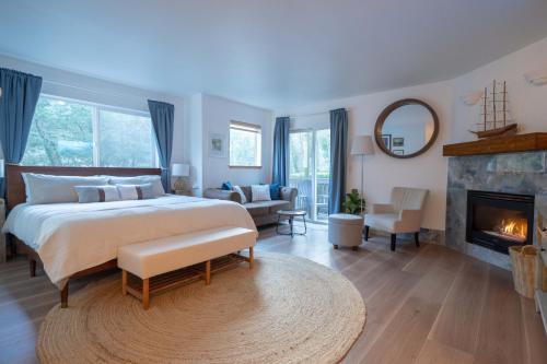 a bedroom with a large bed and a fireplace at Tolovana 3 Cannon Beach in Cannon Beach