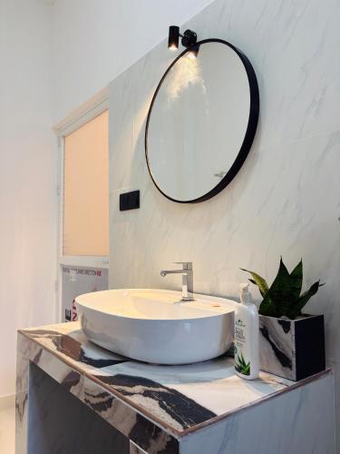 a bathroom with a sink and a mirror on a counter at Blue Cinnamon Cove in Kosgoda