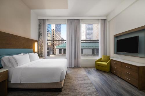 a hotel room with a bed and a large window at EVEN Hotel Pittsburgh Downtown by IHG in Pittsburgh