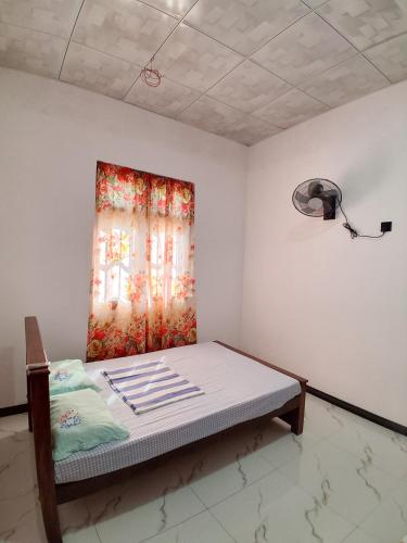 a bed in a room with a window at Lagora Villa in Moraketiara