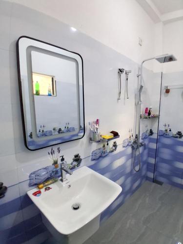 a bathroom with a white sink and a mirror at Lagora Villa in Moraketiara