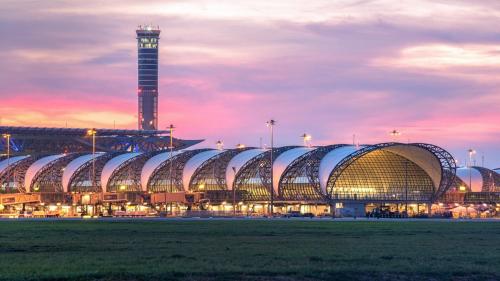 a large stadium with a clock tower in the background at Hostel Bangkok Airport Comfort By MaTong " Near Suvarnabhumi Airport BKK " in Suvarnabhumi Airport