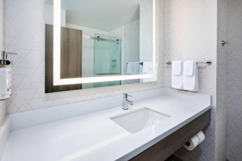 a white bathroom with a sink and a mirror at Holiday Inn Express Casper I-25 by IHG in Casper