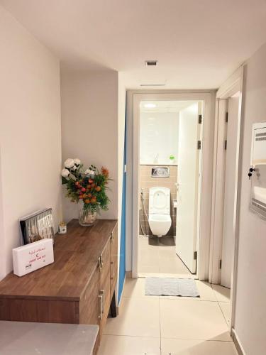 a bathroom with a sink and a toilet in a room at 2 Bedroom Deluxe Beach Apartment Al Marjan in Ras al Khaimah