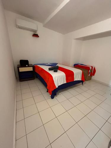 a bedroom with two beds and a tiled floor at Grandma House in Carolina