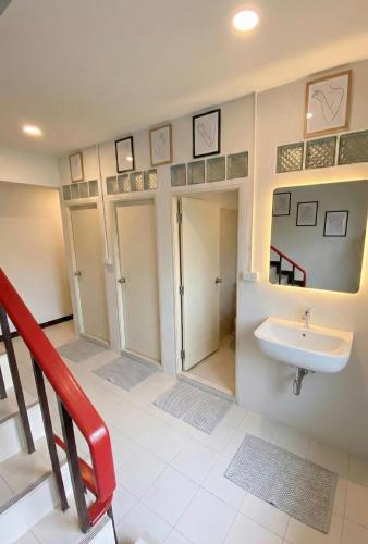 a bathroom with a sink and a staircase at Hostel Bangkok Airport Comfort By MaTong " Near Suvarnabhumi Airport BKK " in Suvarnabhumi Airport