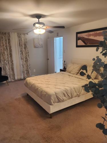 a bedroom with a bed and a ceiling fan at The Carneys Point Cottage in Friendship Station