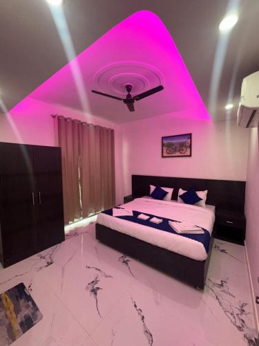 a bedroom with a bed with a pink ceiling at Cabana suites in Rishīkesh