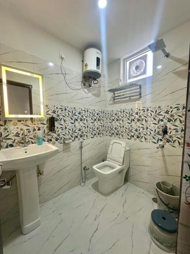 a bathroom with a sink and a toilet at Cabana suites in Rishīkesh