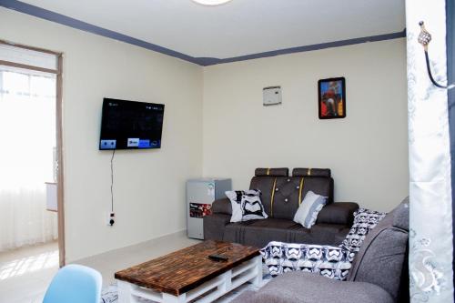 a living room with a couch and a table at Happy Home Ke in Isiolo