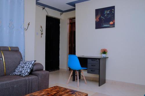 a living room with a couch and a desk at Happy Home Ke in Isiolo