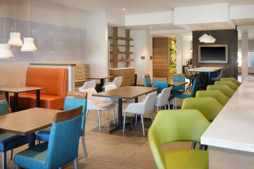 a dining room with tables and chairs at EVEN Hotels Denver Tech Center-Englewood by IHG in Centennial