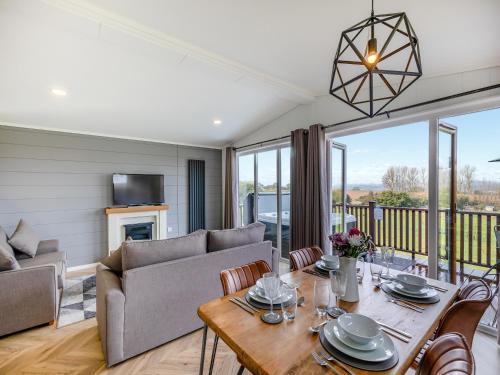 a living room with a couch and a table at Billy Goat Lodge in Crossway Green